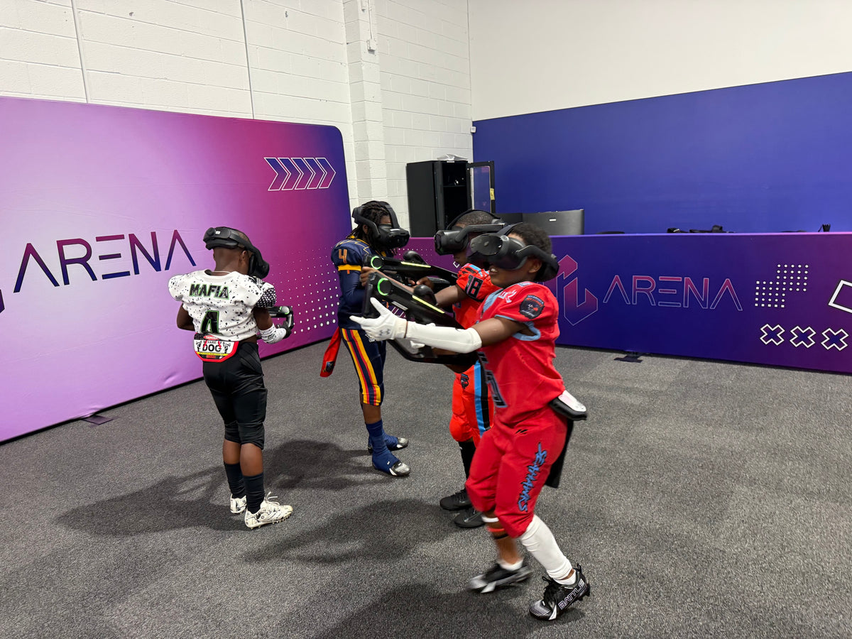 Youth football team in uniforms playing VR together in the Free Roam arena